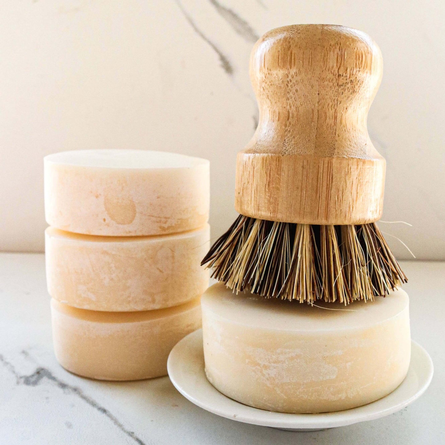 Solid dish soap bar with a bamboo dish brush, eco-friendly cleaning solution for plastic-free dishes.