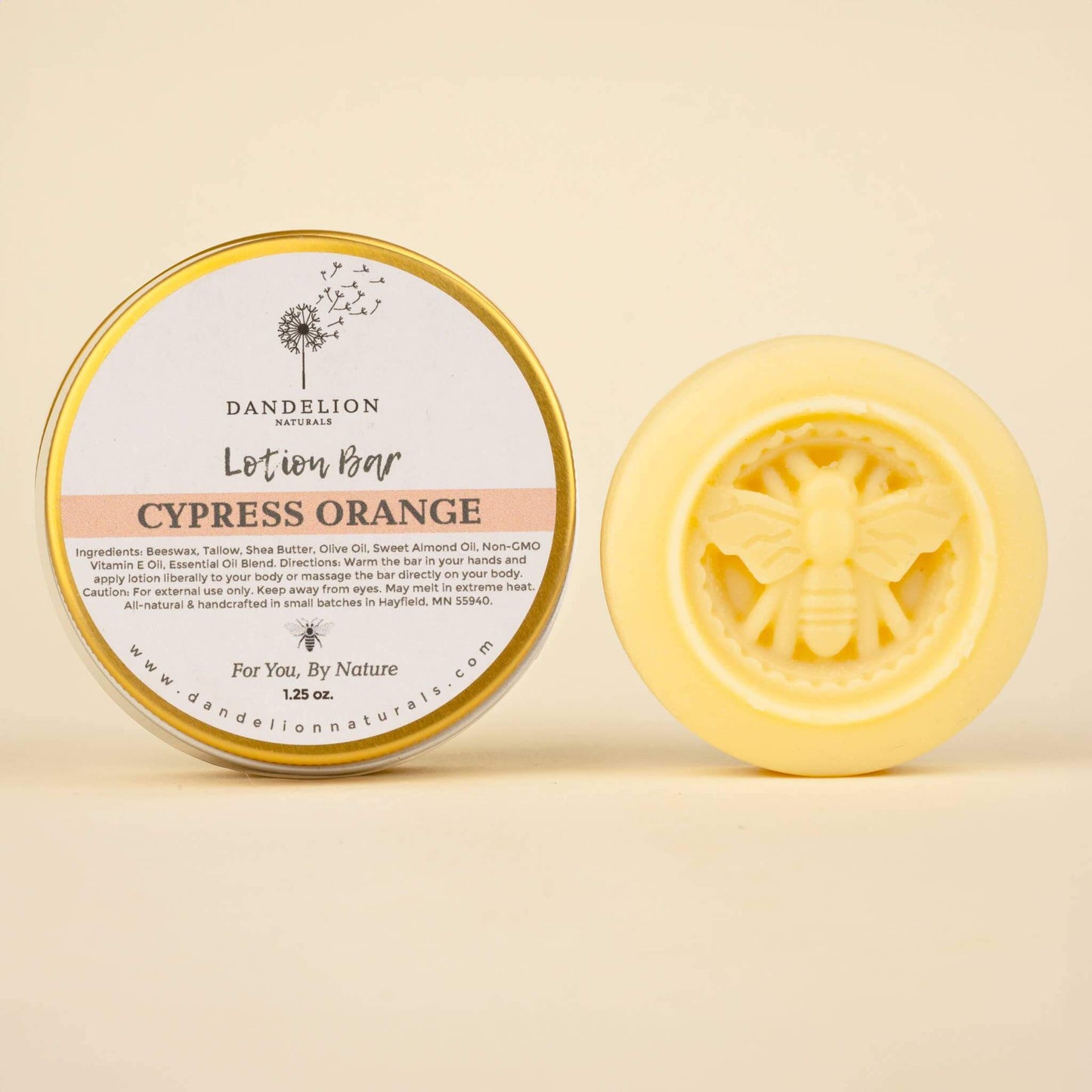 Natural lotion bar in cypress orange scent, featuring bee design, packaged by Dandelion Naturals for smooth moisturizing.