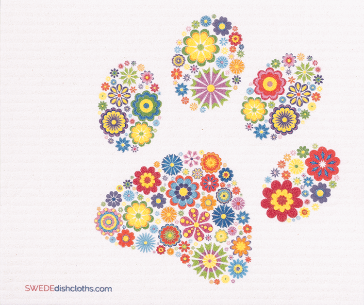 Colorful floral-patterned Swedish dishcloth featuring a dog paw design, made from eco-friendly materials.