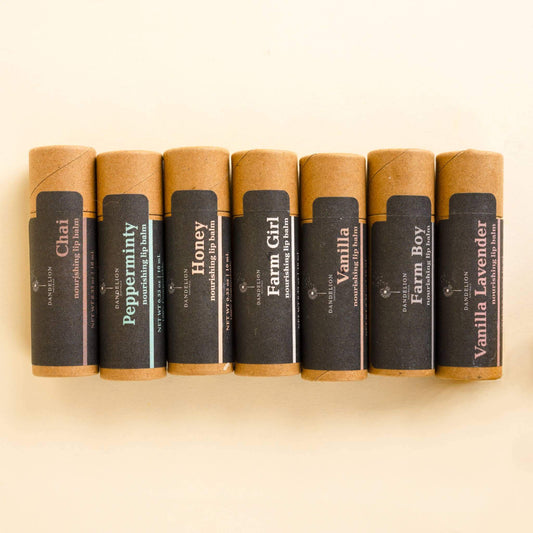 Chai, Peppermint, Honey, Farm Girl, Vanilla, Farm Boy, Vanilla Lavender lip balm sticks displayed in a row.