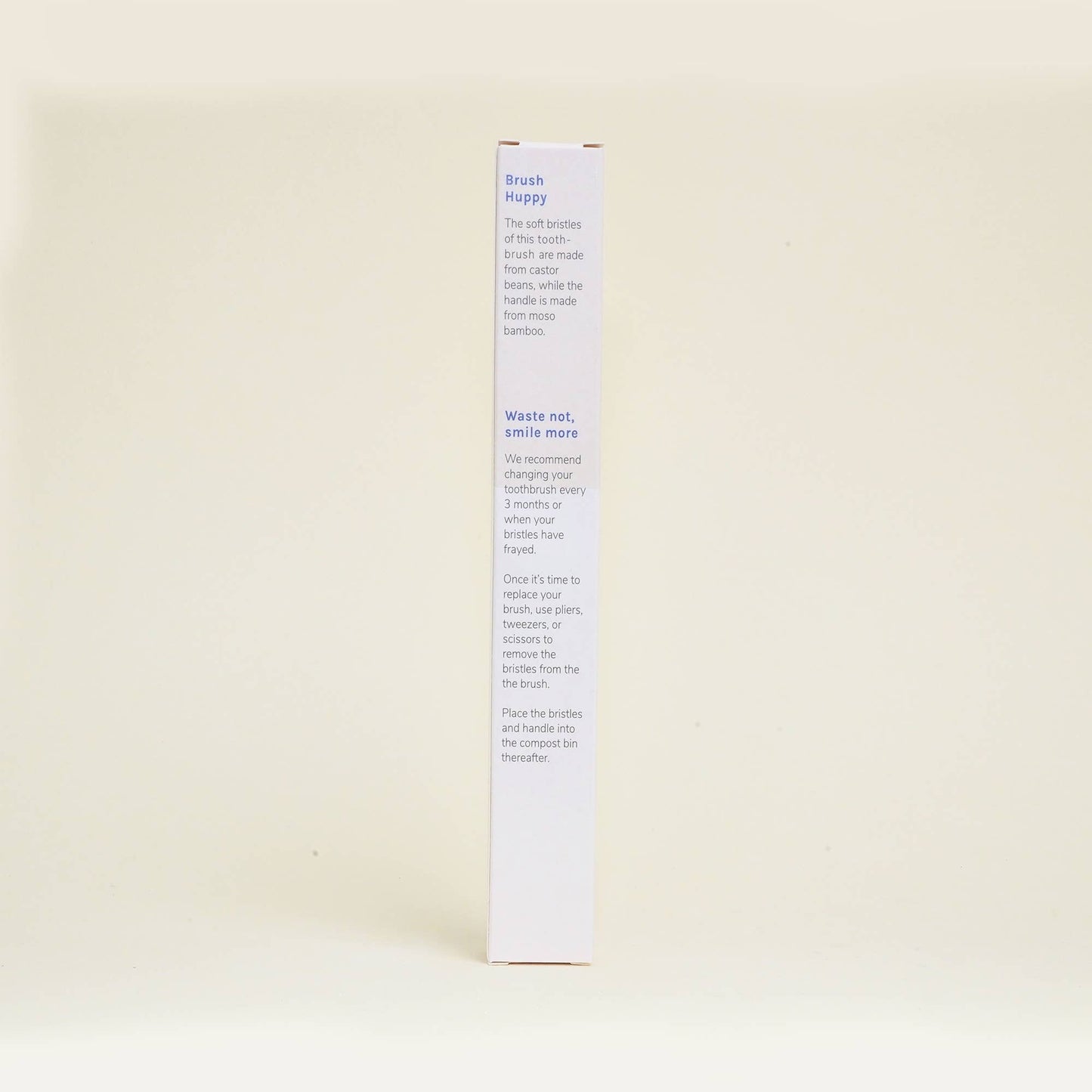 Side view of Huppy bamboo toothbrush packaging with eco-friendly instructions and waste reduction message.