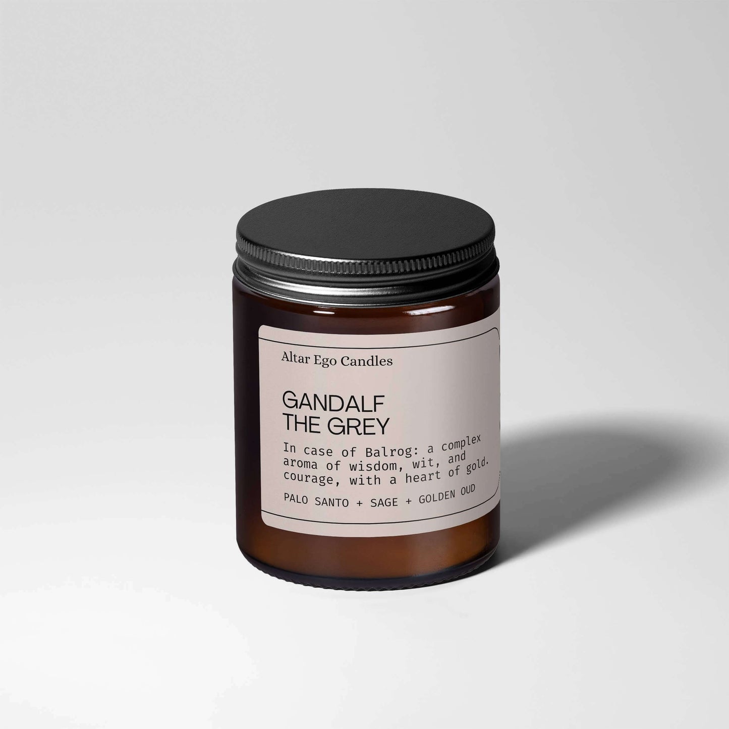 WoodWick Candle GANDALF THE GREY with notes of palo santo, sage, and golden oud in a stylish amber jar.