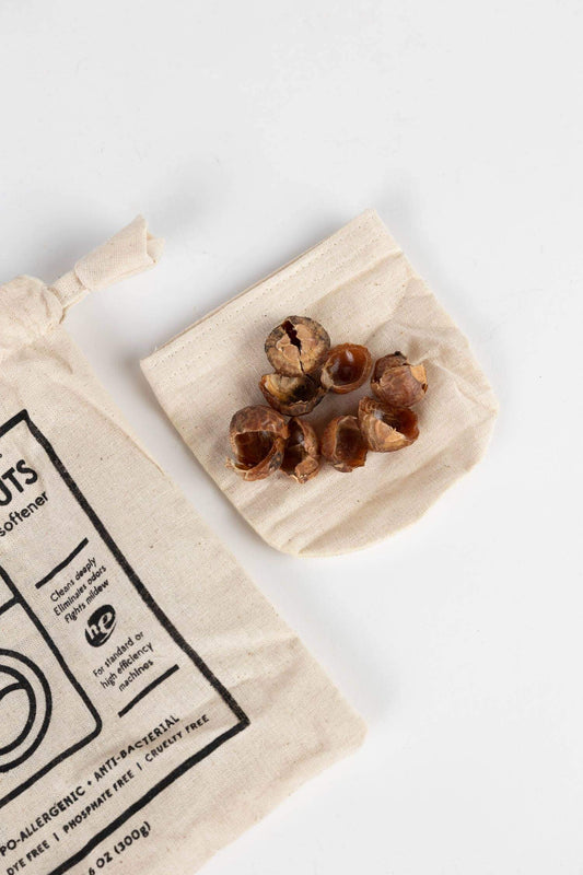 Laundry Soap Nuts - All Natural Detergent - Non-Toxic - Eco-Friendly in a cotton bag with cleansing nuts.