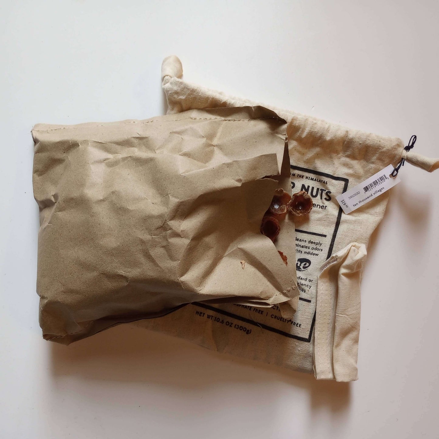Laundry Soap Nuts - All Natural Detergent - Non-Toxic - Eco-Friendly in a natural cotton drawstring bag with packaging.