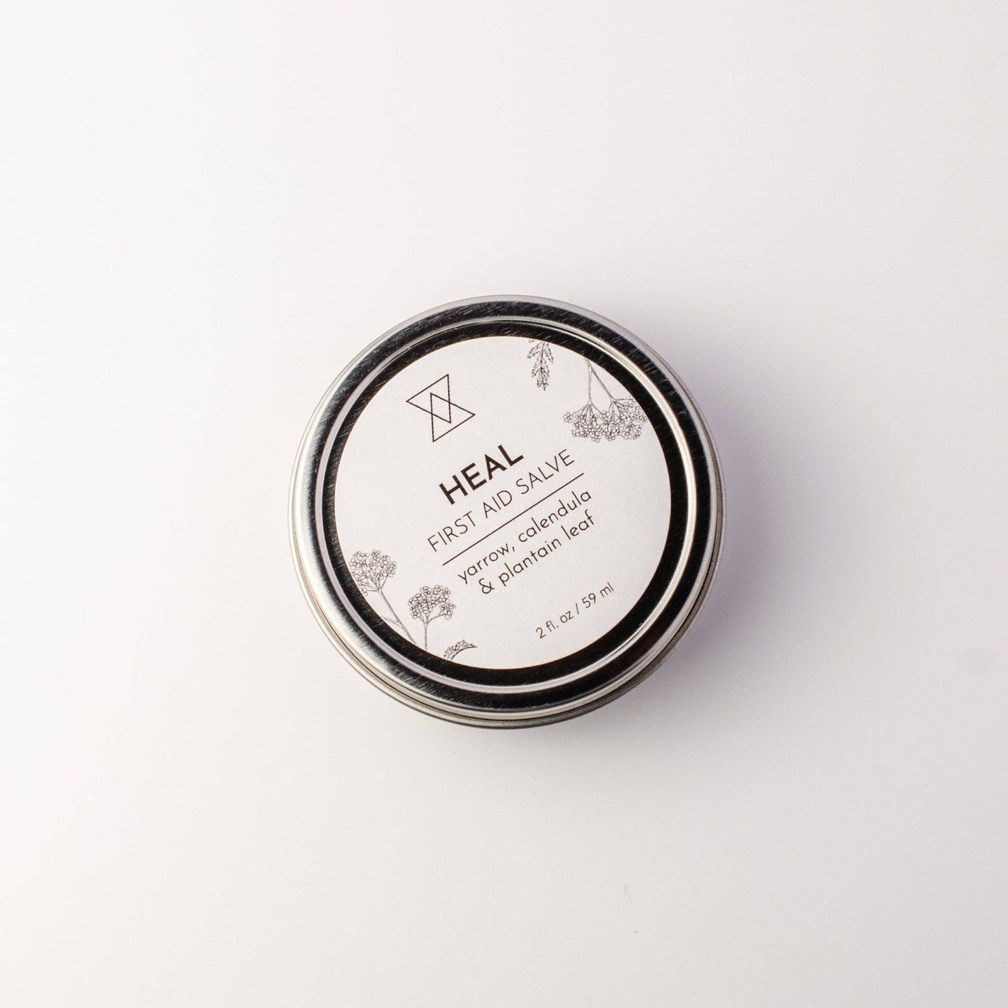 Heal First Aid Salve in a 2 oz screw-top tin, formulated with healing herbs for cuts, scrapes, and burns.