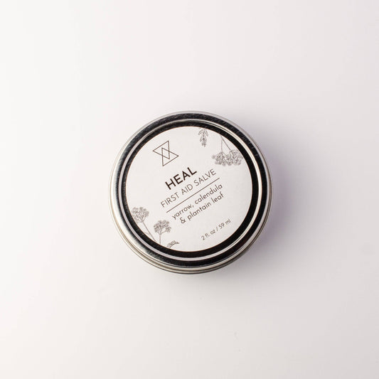 Heal First Aid Salve in a 2 oz screw-top tin, formulated with healing herbs for cuts, scrapes, and burns.