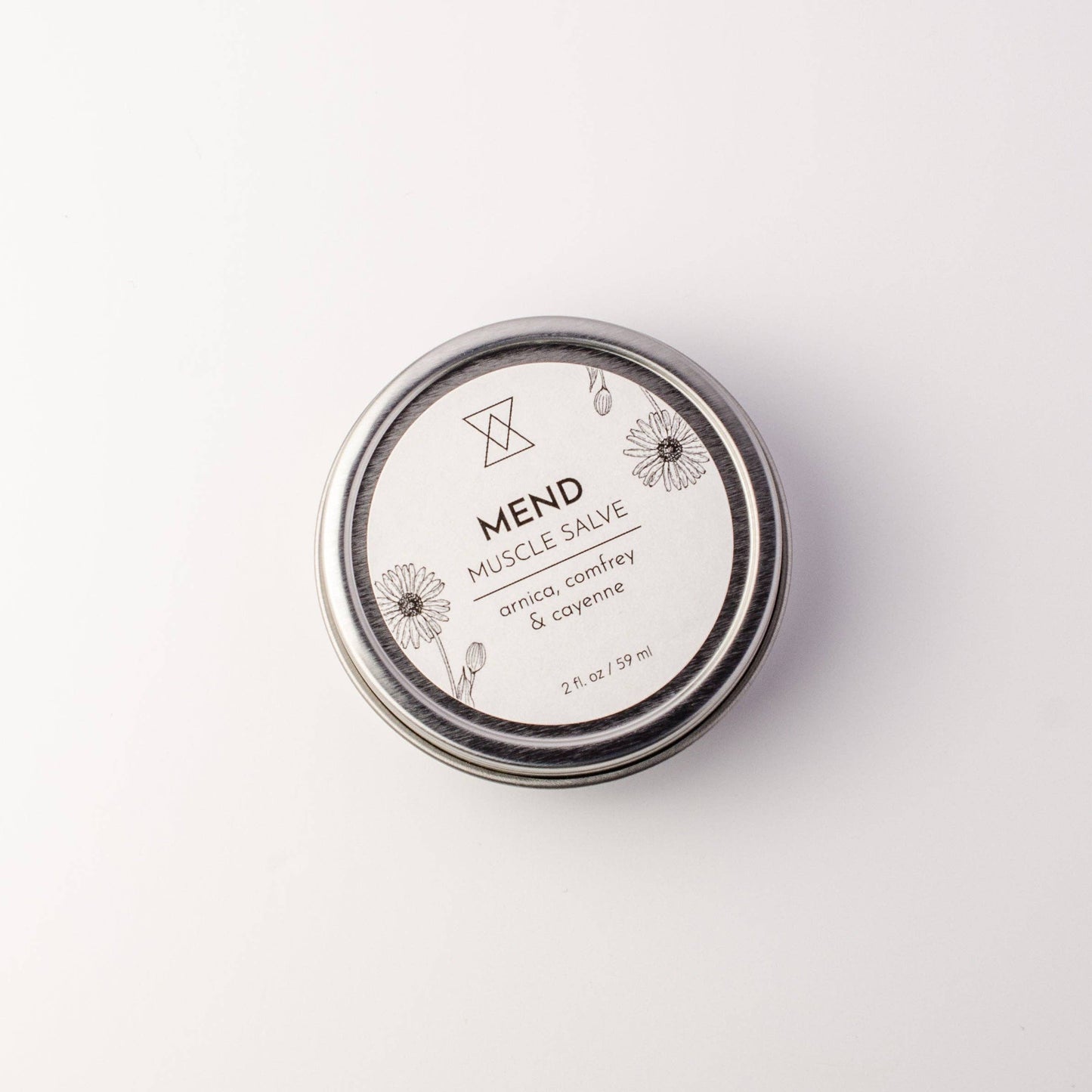 Mend muscle salve tin featuring organic ingredients like arnica and comfrey for sore muscle relief.