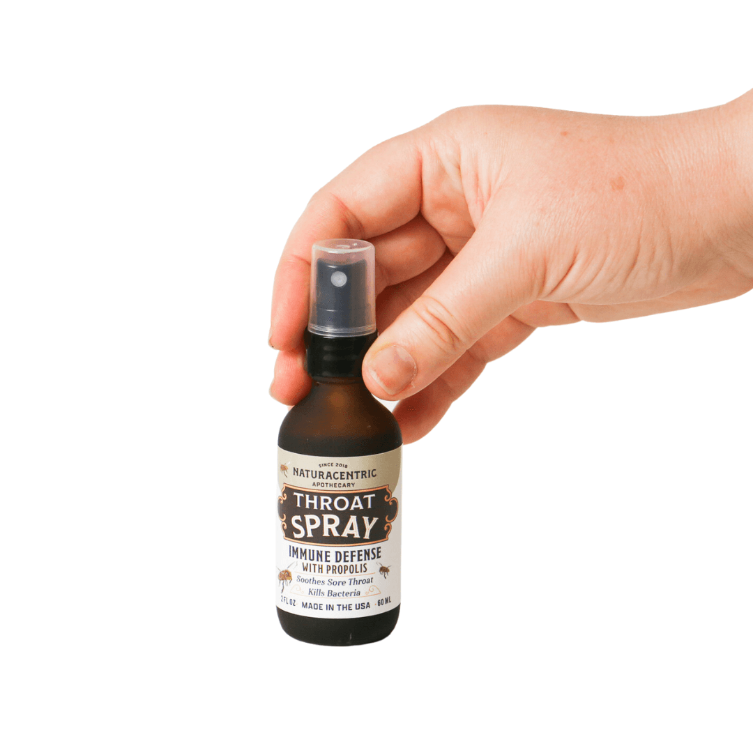 Immune Defense Throat Spray with Propolis & Honey held in hand, promoting immune support and soothing throat irritation.