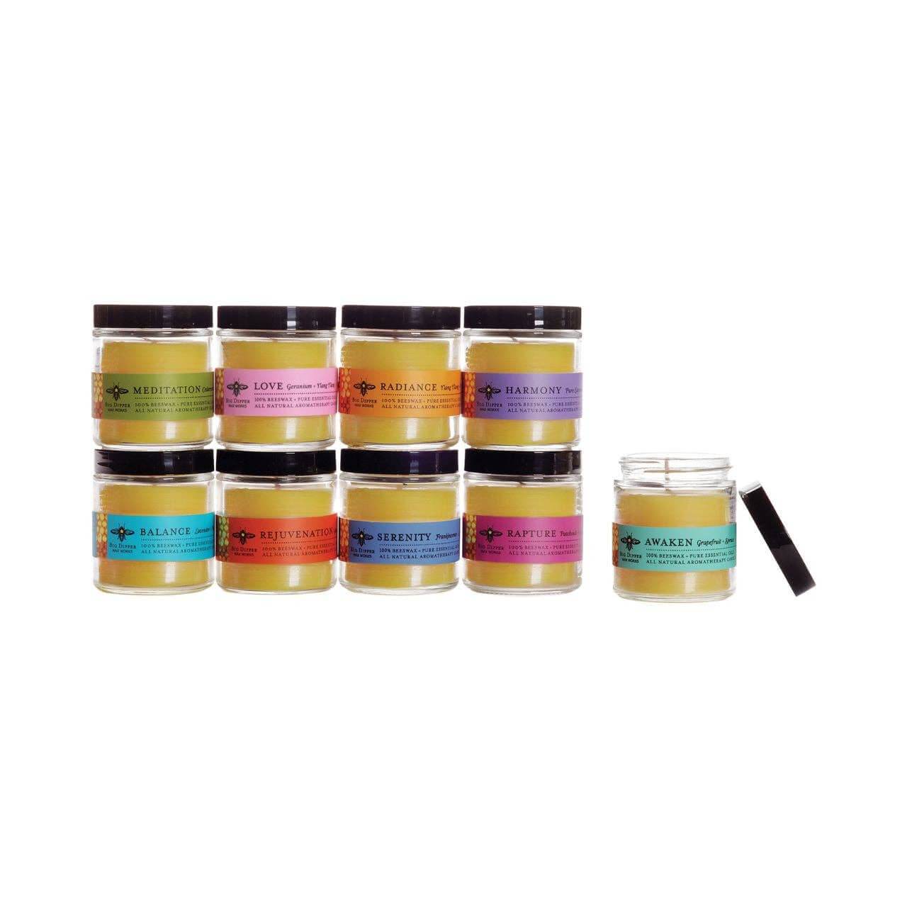 Collection of aromatherapy candles in glass jars, featuring scents like Radiance, Love, and Serenity.