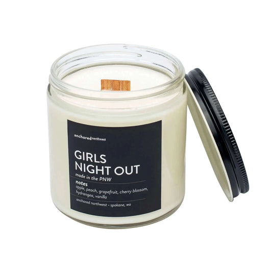 large soy candle in clear glass with cedar wood wick in girls night out scent