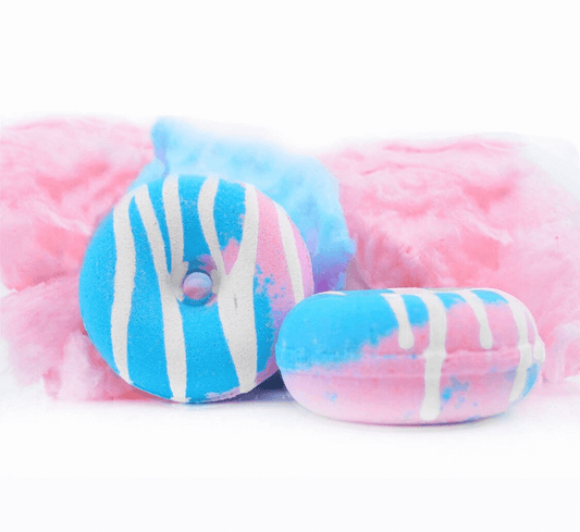 donut shaped bath bomb in cotton candy scent with cotton candy background