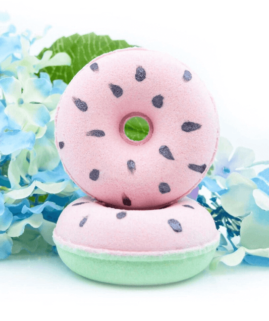 double stacked donut shaped watermelon bath bombs with flower background