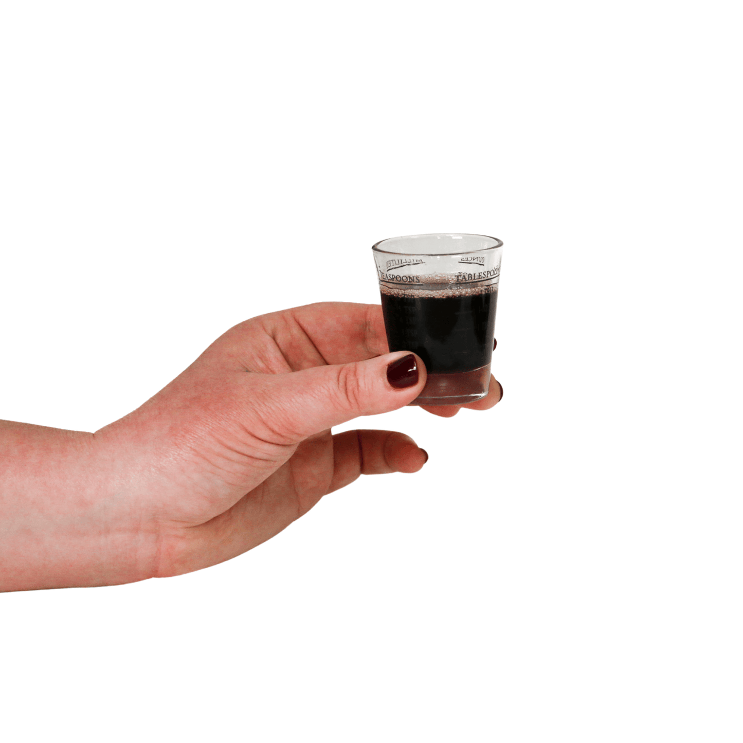 Elderberry Syrup Wellness Elixir: 8oz in a glass shot held by a hand, showcasing its dark color and rich texture.