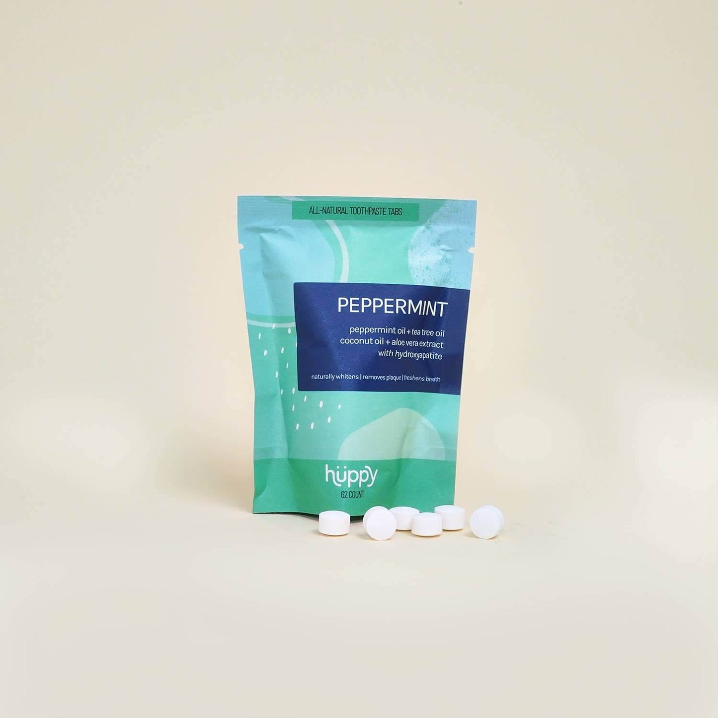 Hüppy eco-friendly peppermint toothpaste tablets refill pouch with white tablets on a light background.
