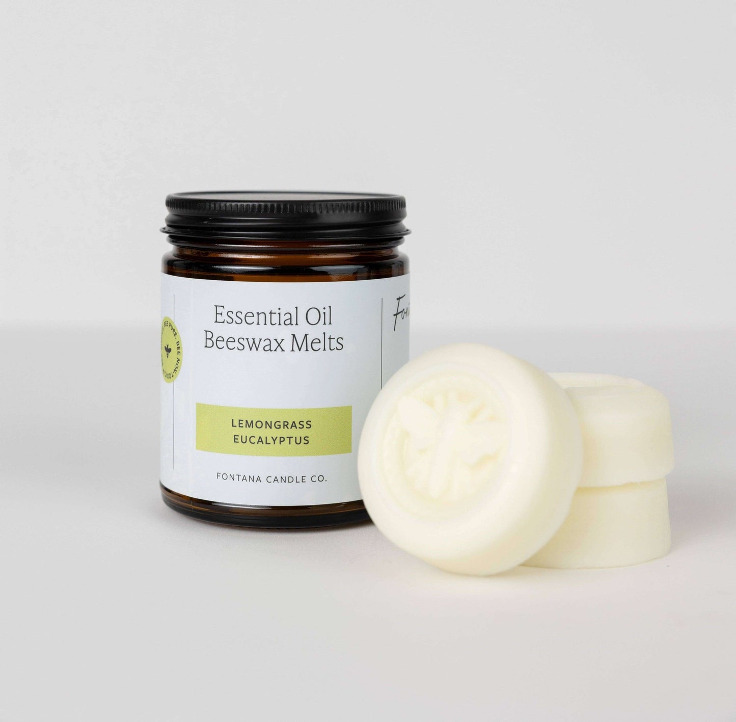 Lemongrass Eucalyptus Beeswax & Essential Oil Wax Melts in a jar with wax melts beside it.