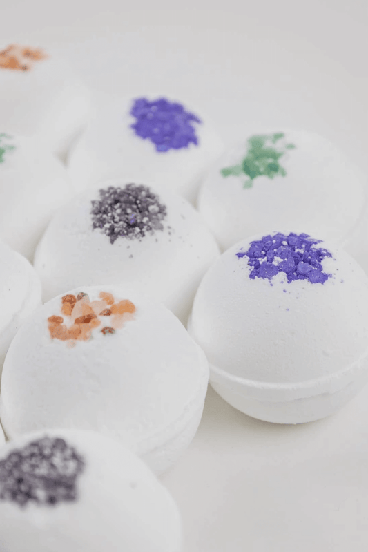 Several all natural bath bombs sitting next to each other. 