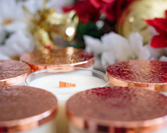 Mountain Lodge Seasonal Soy Candle 16oz Winter - Non Toxic Candle with hammered copper lids surrounded by festive decor.