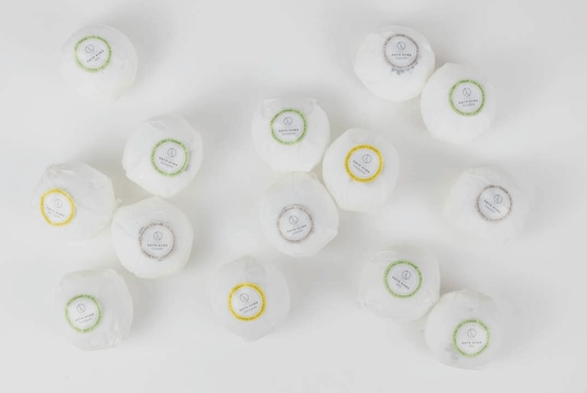 All natural Lizush bath bombs wrapped in waxed paper.