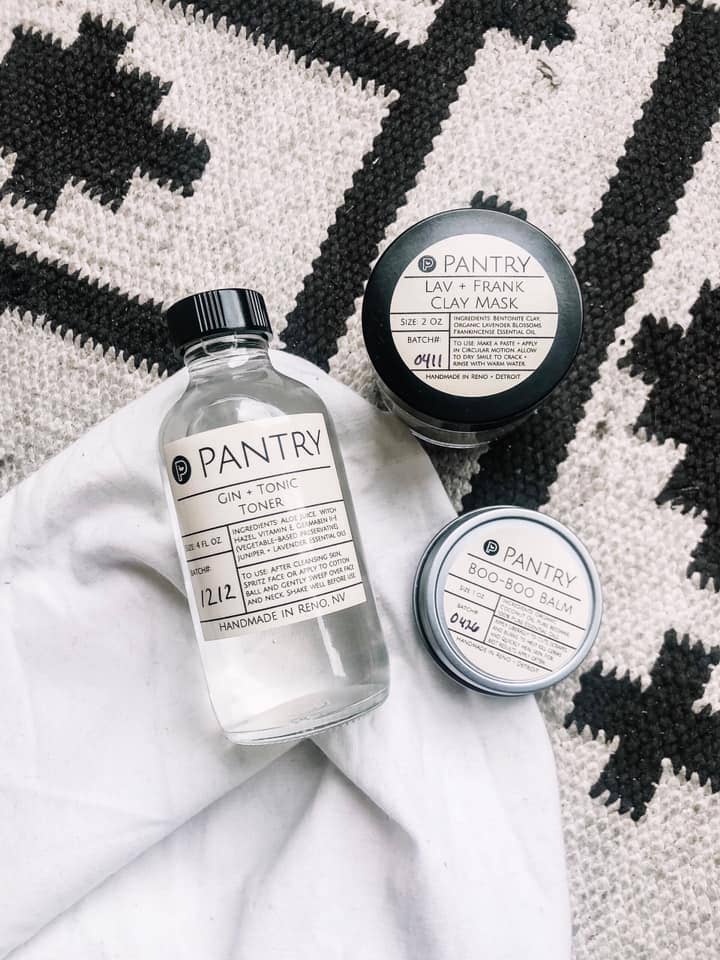 Pantry Gin Tonic Toner, Lav + Frank Clay Mask, Boo Boo Balm on a textured surface for natural skincare.