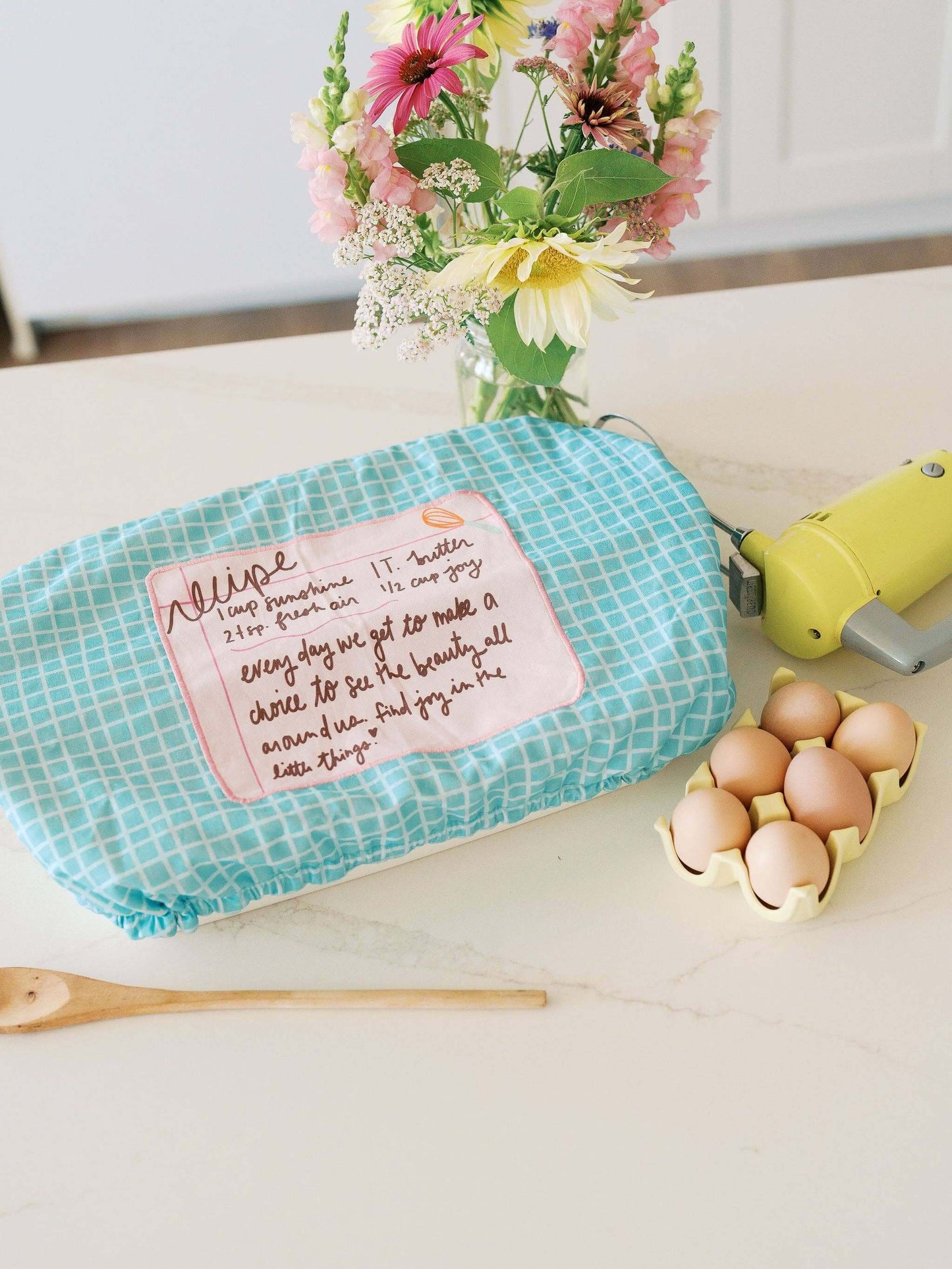 Recipe for a Happy Heart 10x14 Baking Dish Cover | Baking with cheerful design and fresh flowers on kitchen counter.