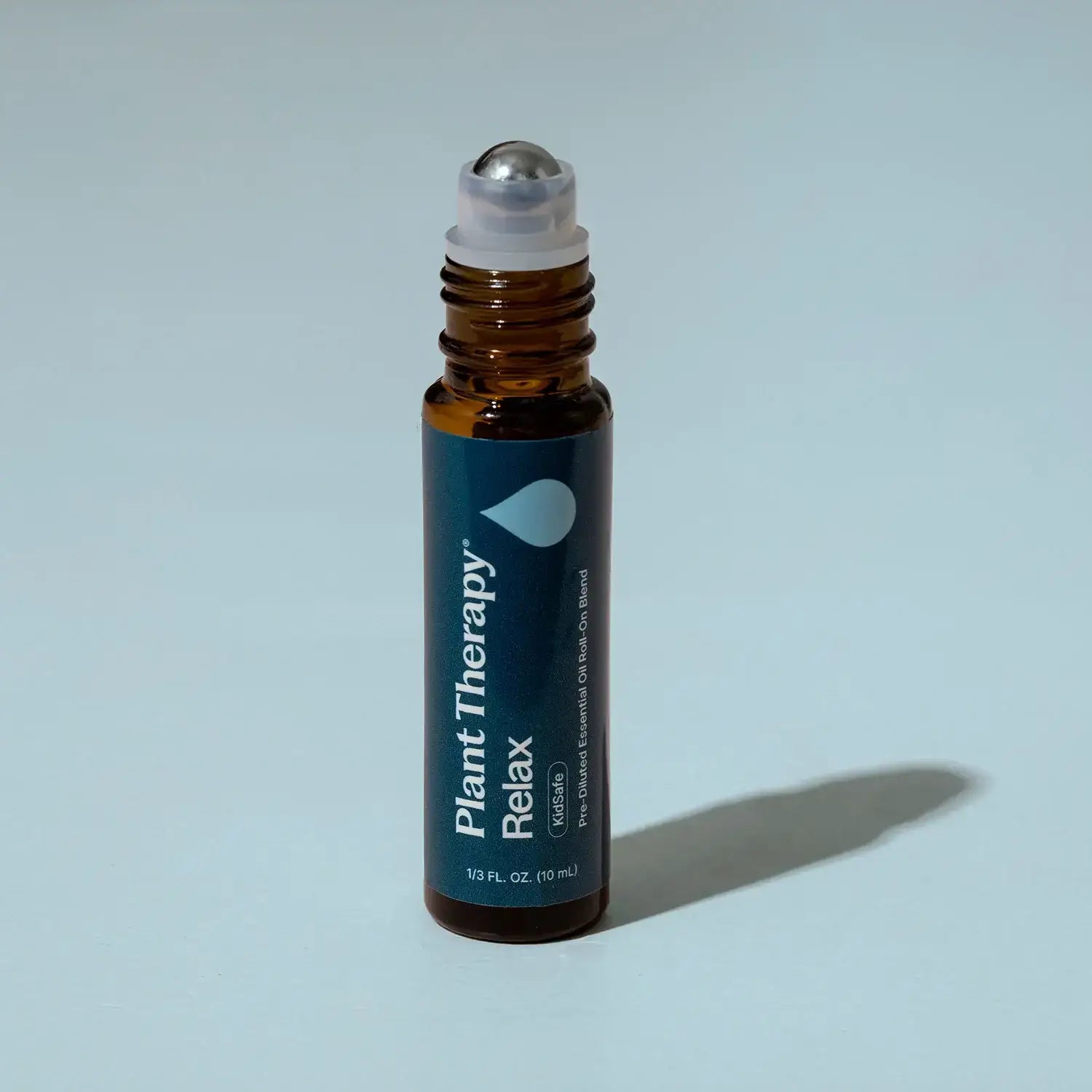 Pre-diluted roll-on bottle of Plant Therapy Relax Essential Oil Blend for promoting tranquility.