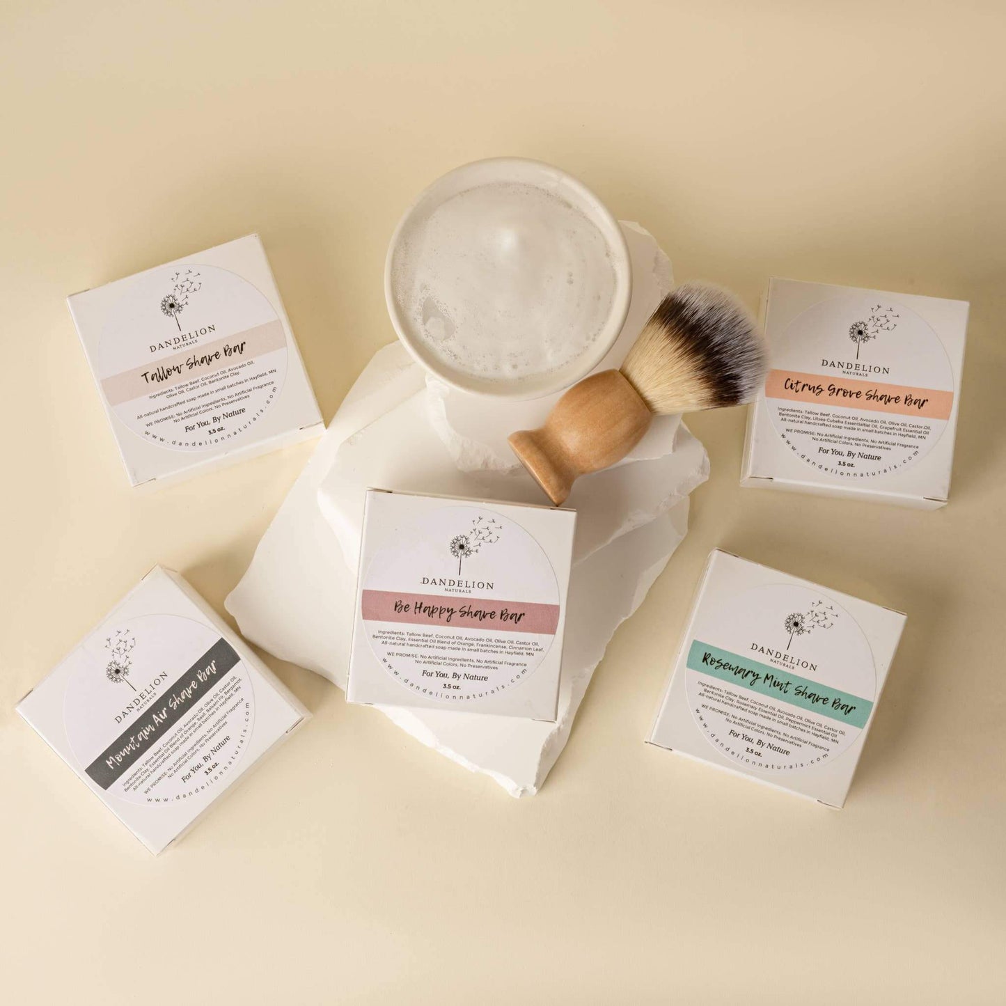 Tallow shave soaps displayed with a shaving brush, featuring Citrus Grove and other scents for a moisturizing shave.