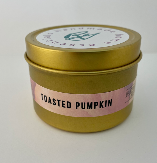 Gold tin travel candle in a toasted pumpkin scent.