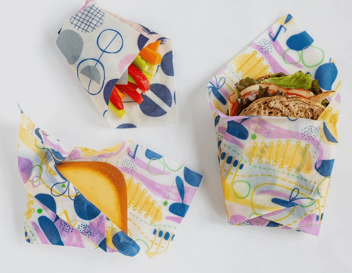 zwraps, reusable beeswax food wraps, made into storage bags, holding a sandwich, bread and vegetables for travel