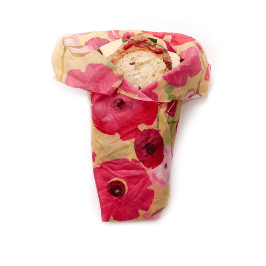 Zwraps, reusable beeswax food wrap, in poppies design wrapped around a large sandwich.
